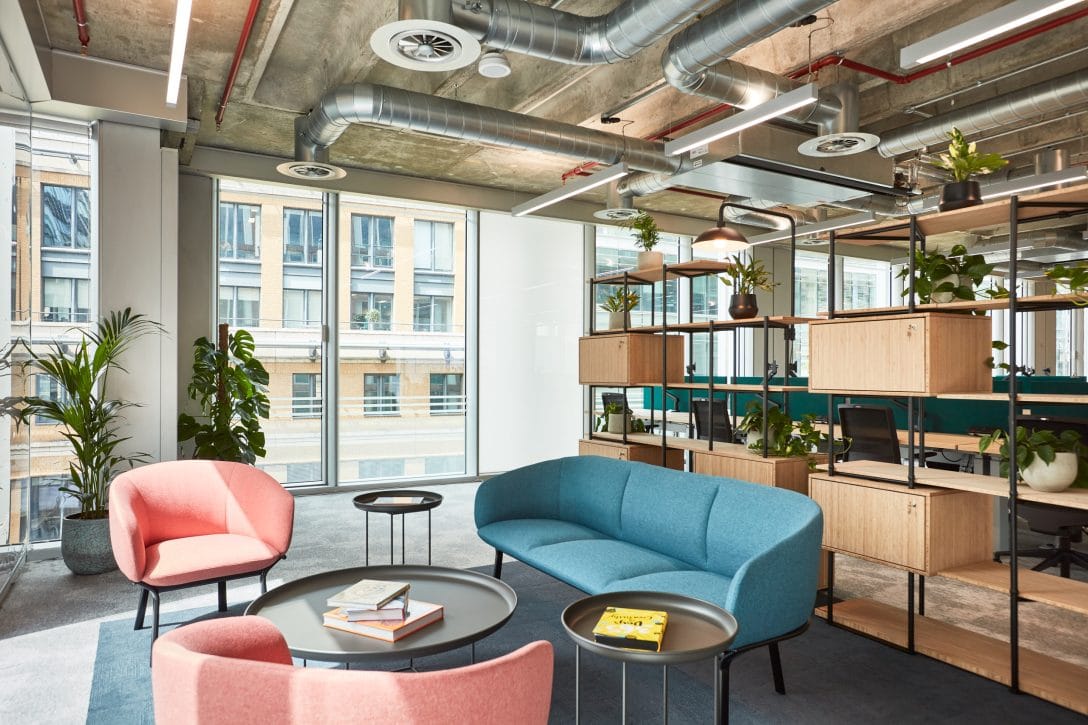 An office break out space filled with natural light and comfortable furniture to promote positive workplace mental health.