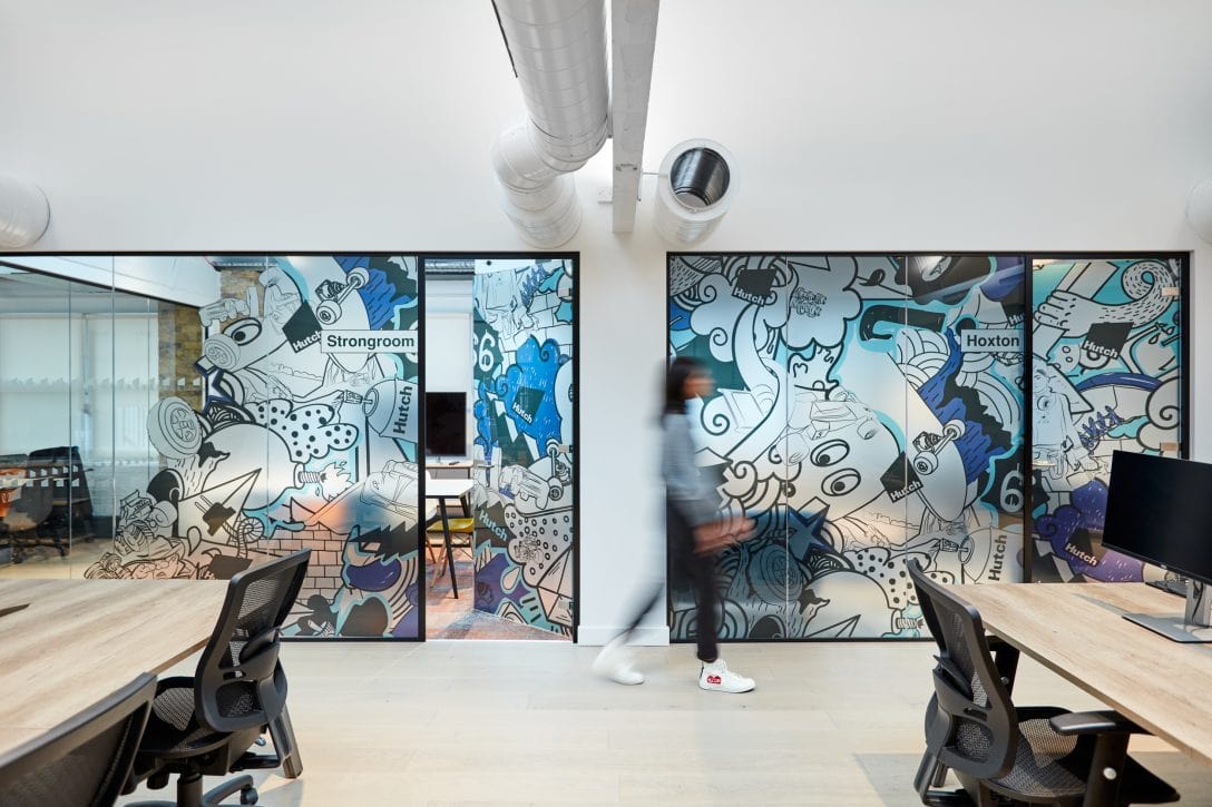 Colourful branded manifestation lines the meeting room walls inside Hutch offices.