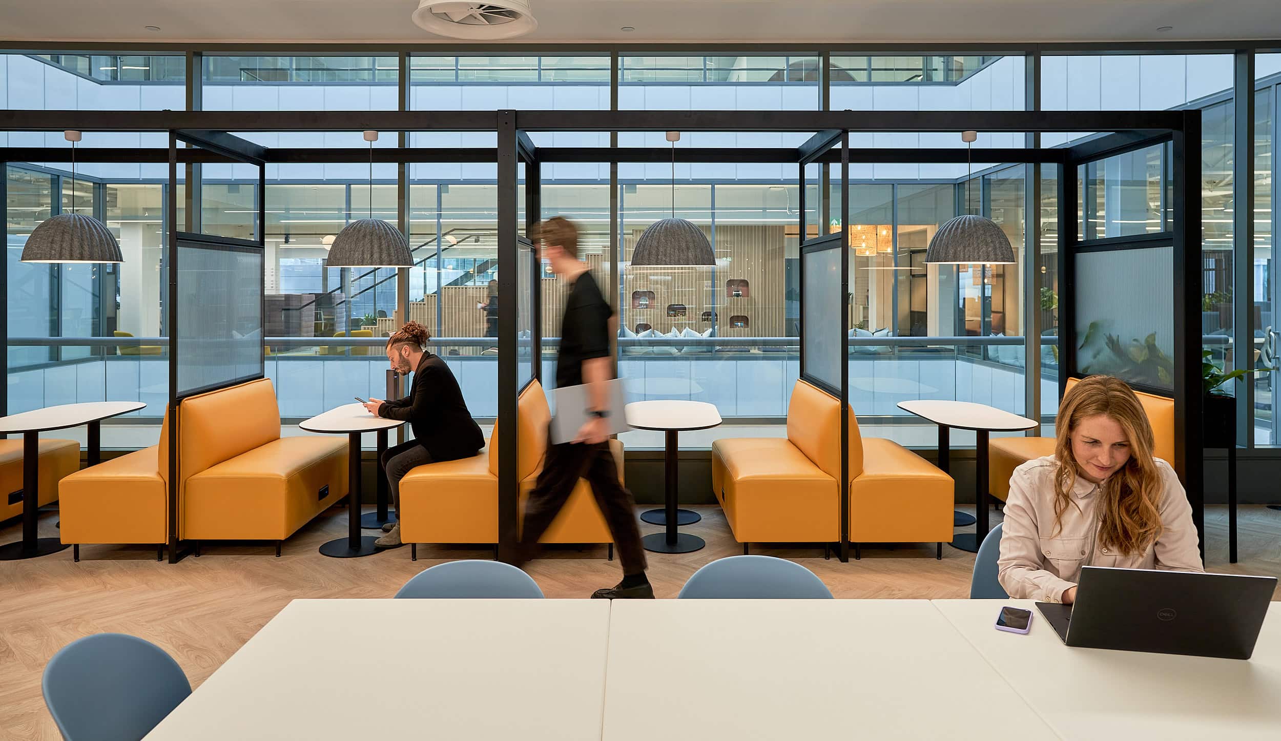 Braze office designed and built by AIS busy with people working on laptops in their open collaboration zone.