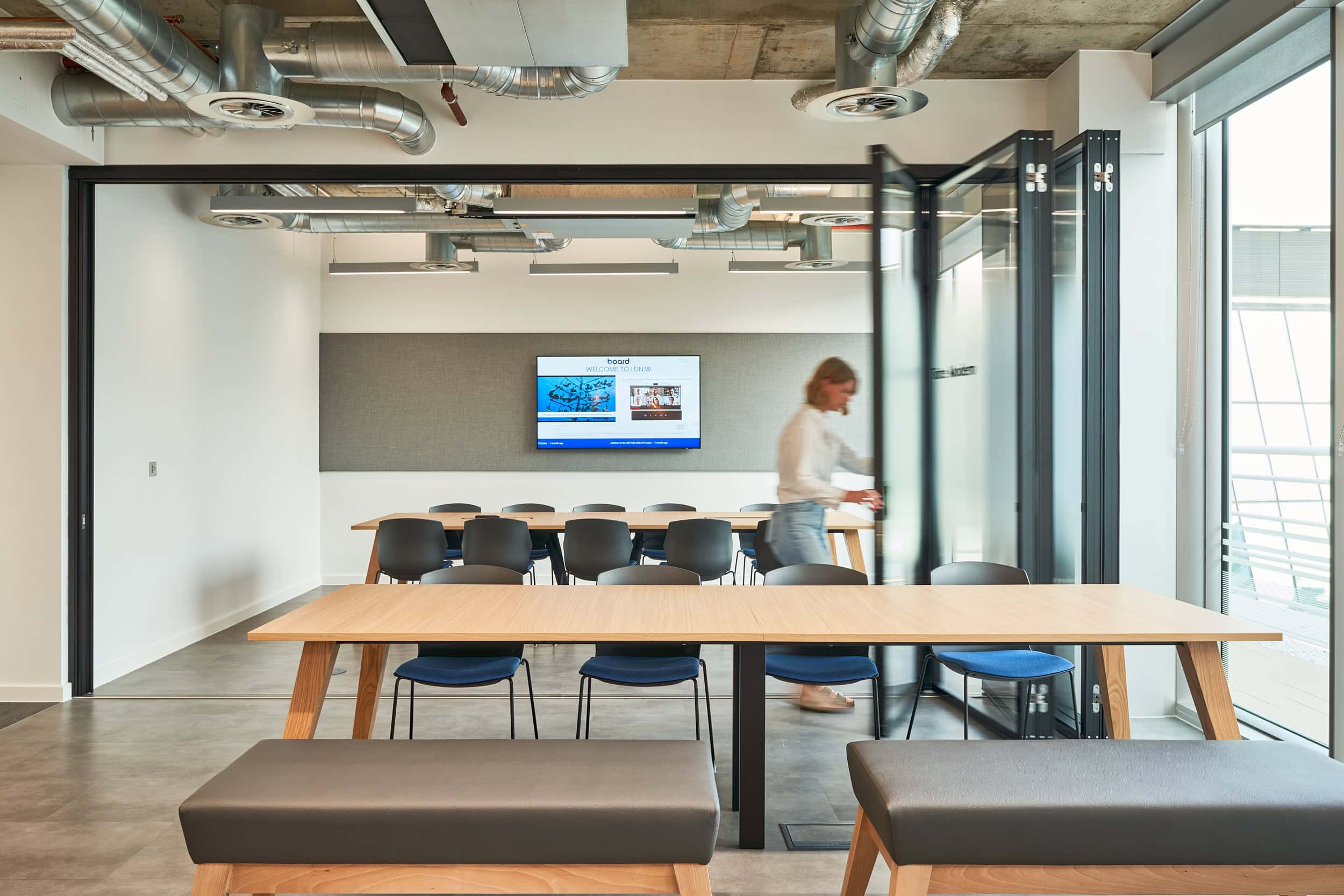 A girl is shown inside an agile meeting room with retractable walls.