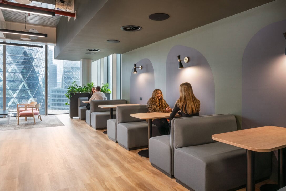 Booths in reception area with detailed lighting on the wall above